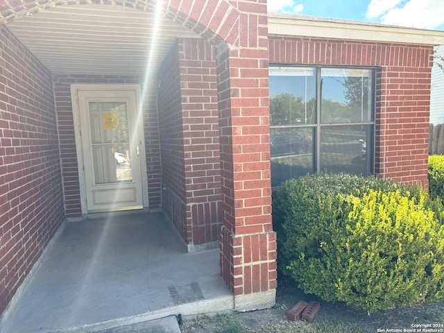 property entrance with brick siding