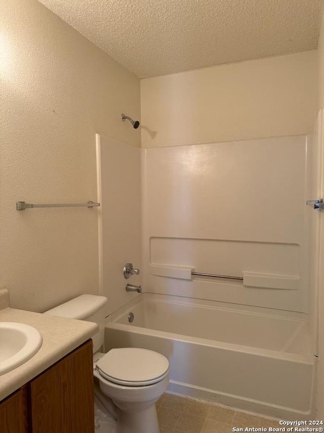 full bath with shower / bath combination, a textured ceiling, vanity, and toilet