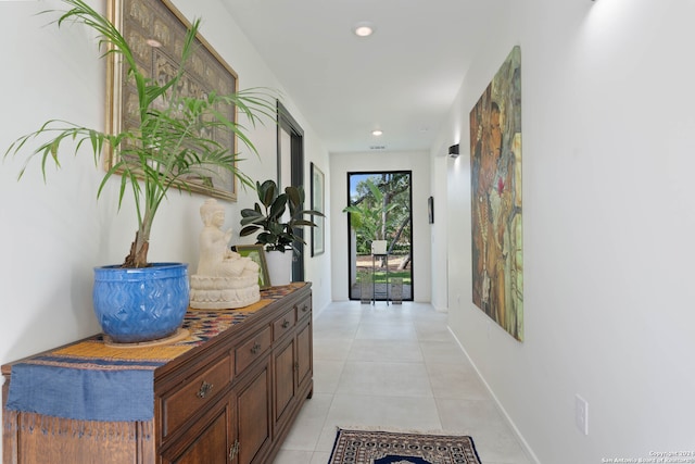 hall with light tile patterned floors