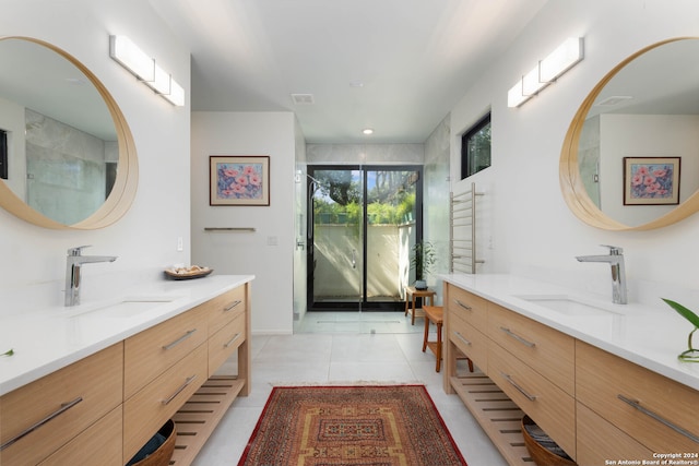 bathroom featuring tile patterned flooring, vanity, and an enclosed shower