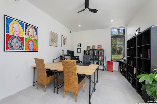 dining space with expansive windows and ceiling fan