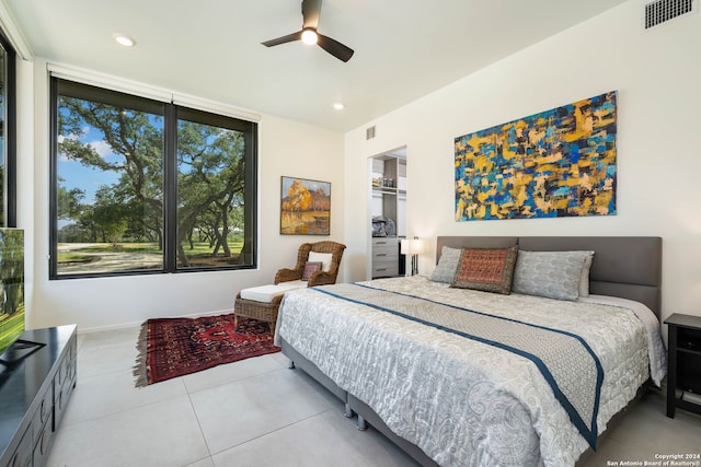 bedroom with ceiling fan and light tile patterned floors