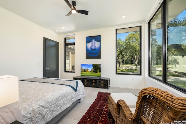 tiled bedroom with multiple windows and ceiling fan