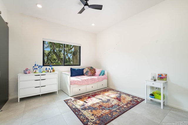 bedroom with ceiling fan and light tile patterned floors