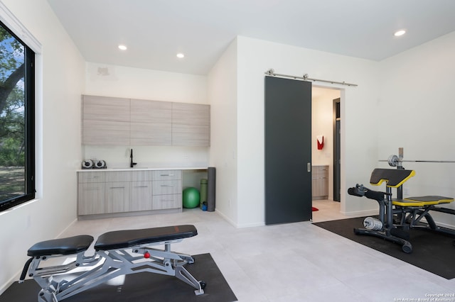 workout room featuring a barn door