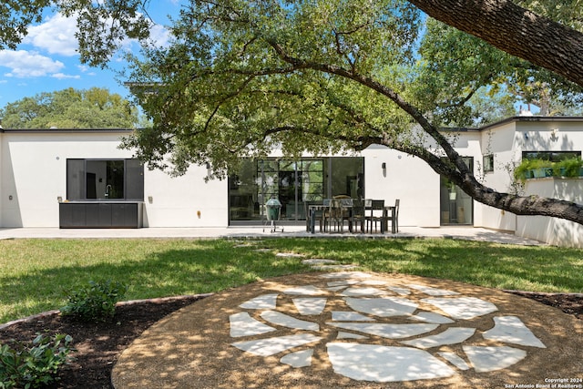 back of property with a patio