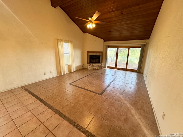 unfurnished living room with ceiling fan, a fireplace, light tile patterned flooring, and wooden ceiling