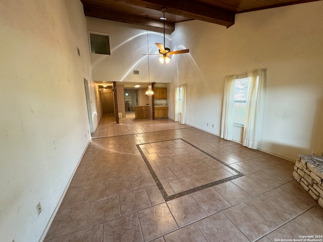 unfurnished living room with high vaulted ceiling, ceiling fan, wood ceiling, beam ceiling, and light tile patterned flooring