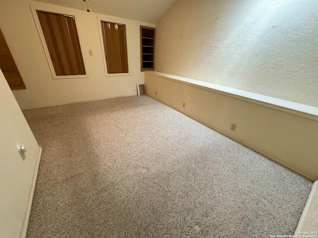 carpeted spare room with a textured ceiling