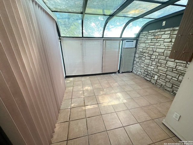 unfurnished sunroom with a wall mounted AC