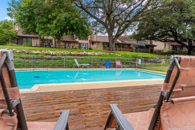 view of swimming pool with a deck