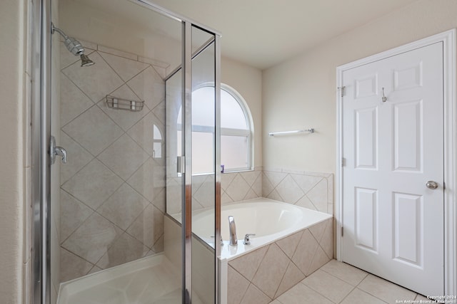 bathroom with independent shower and bath and tile patterned flooring