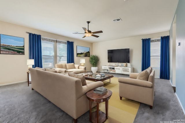 living area with baseboards, carpet, visible vents, and a ceiling fan