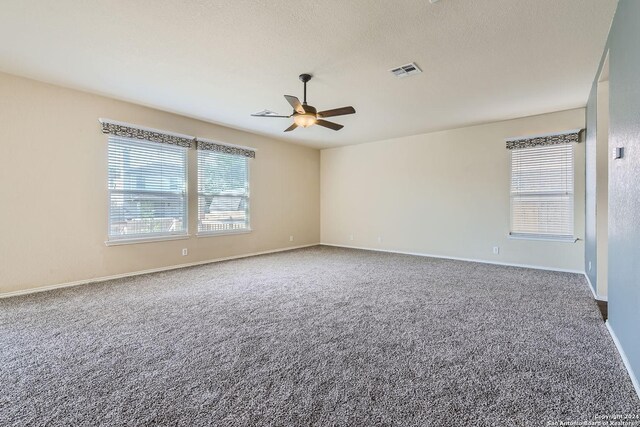 unfurnished room with ceiling fan and carpet floors