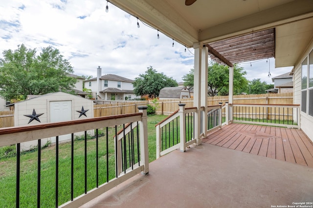 wooden deck with a lawn and a shed