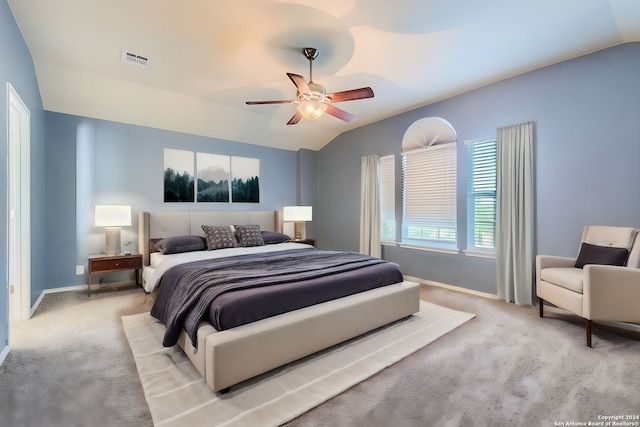 carpeted bedroom featuring lofted ceiling and ceiling fan