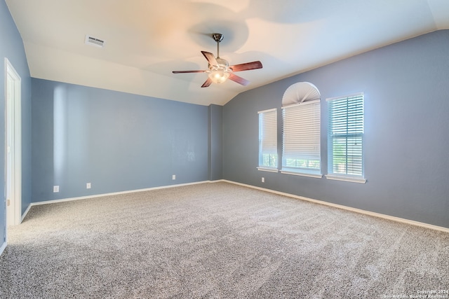 spare room featuring ceiling fan, carpet, and vaulted ceiling