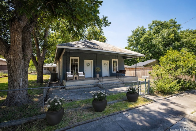 bungalow-style home with central AC and covered porch