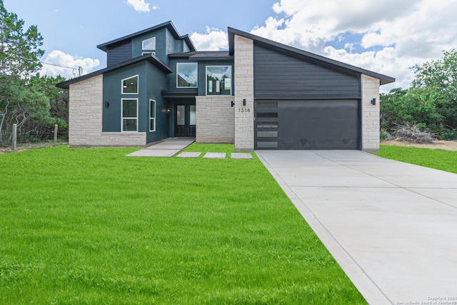 contemporary house with a garage and a front lawn