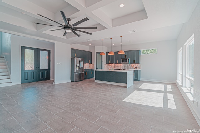 kitchen featuring a kitchen island with sink, coffered ceiling, decorative light fixtures, ceiling fan, and appliances with stainless steel finishes