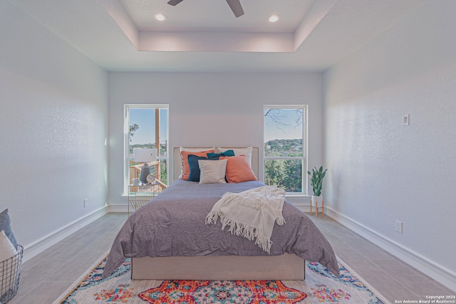 bedroom with a tray ceiling, ceiling fan, baseboards, and recessed lighting