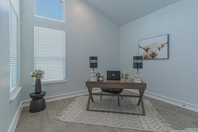 office with lofted ceiling and baseboards