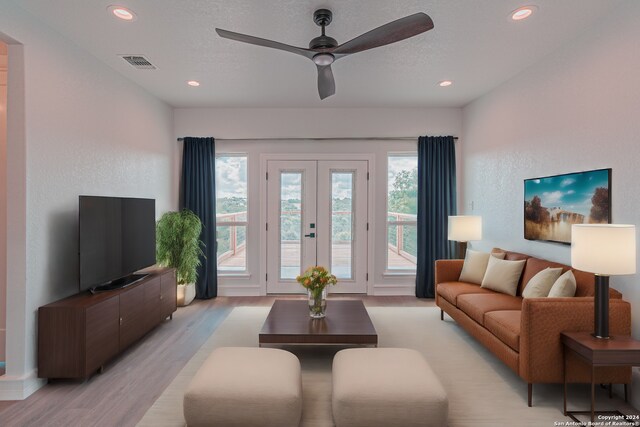 empty room featuring a tray ceiling, ceiling fan, and a wealth of natural light