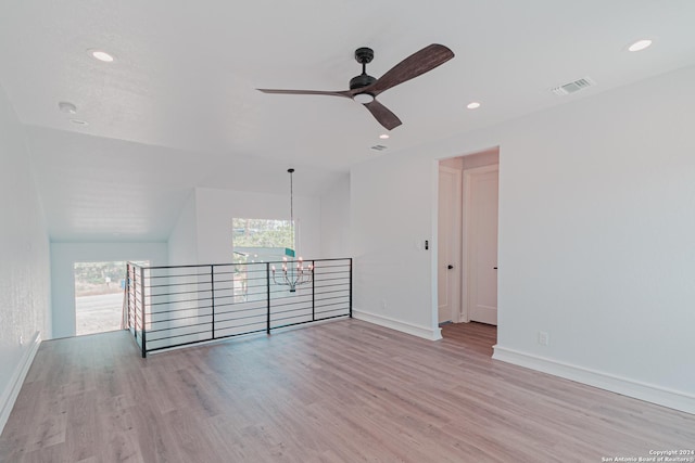 spare room featuring recessed lighting, wood finished floors, visible vents, and baseboards