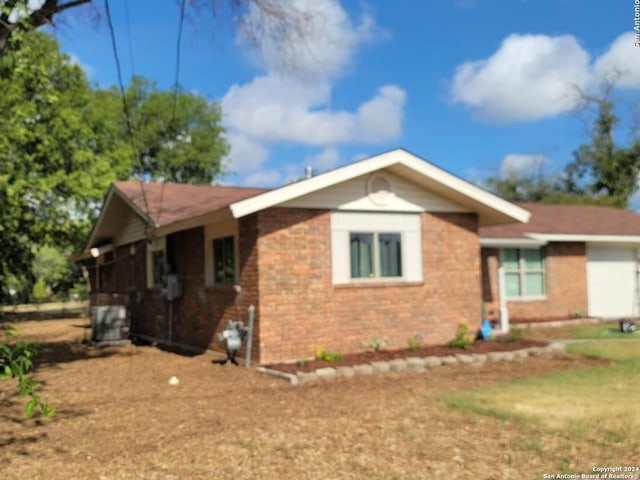 single story home featuring brick siding and an attached garage