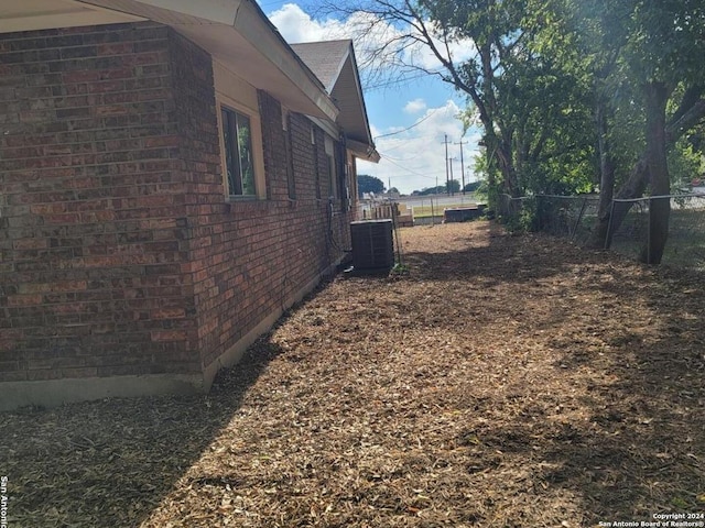 view of side of property featuring central AC unit