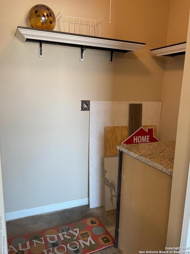 laundry area featuring baseboards