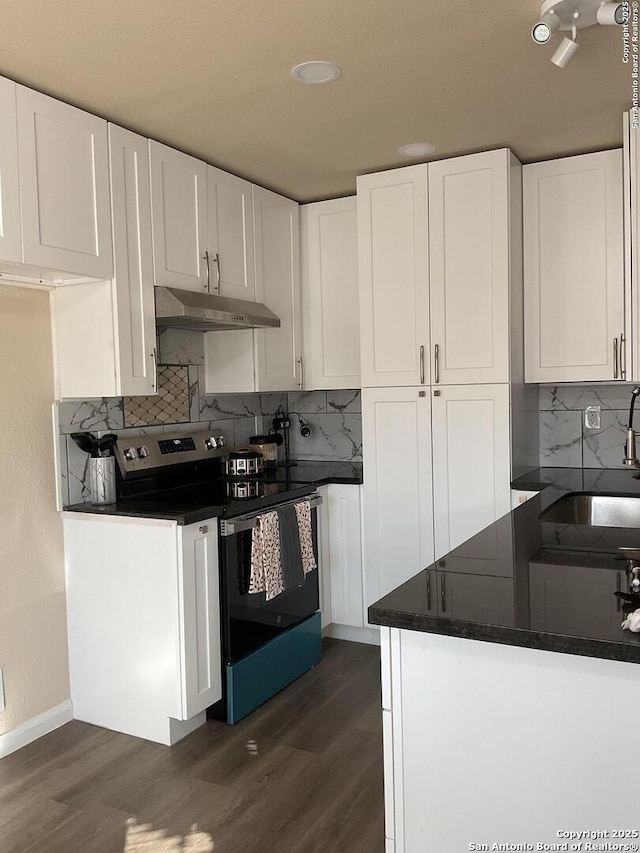 kitchen featuring stainless steel electric range oven, sink, and white cabinets