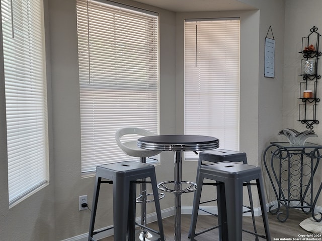 dining space with wood-type flooring