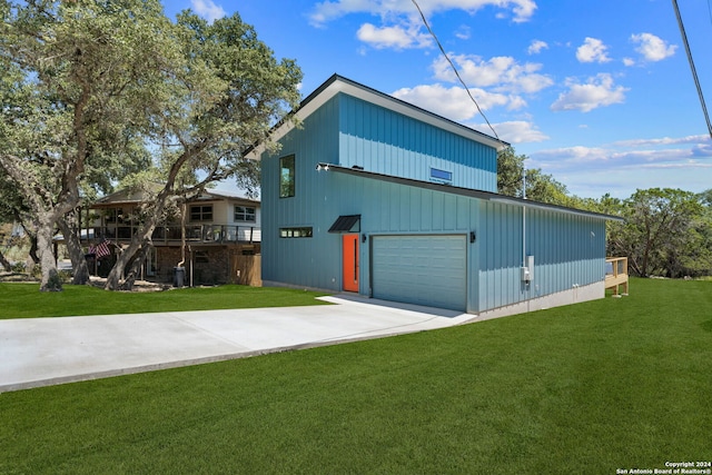 exterior space featuring a front yard, a garage, and a deck