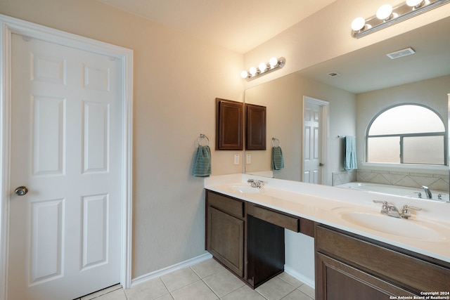 bathroom with a bath, tile patterned flooring, and vanity