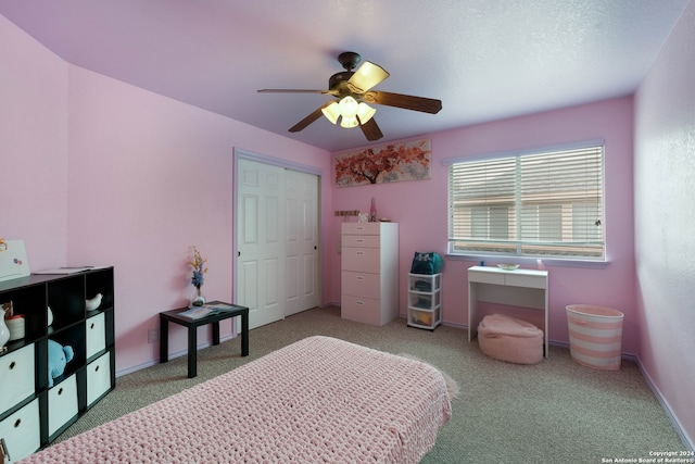 bedroom with carpet flooring, a closet, ceiling fan, and a textured ceiling