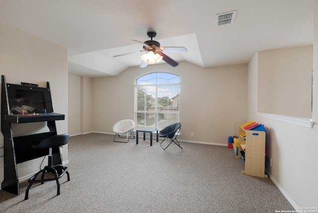 living area with ceiling fan, carpet, and vaulted ceiling