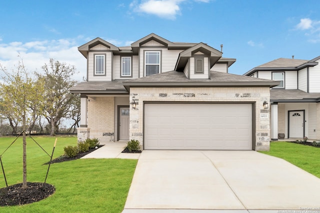 view of front of home with driveway, brick siding, a front lawn, and an attached garage