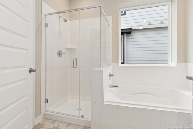 bathroom featuring a shower stall, a bath, and tile patterned floors