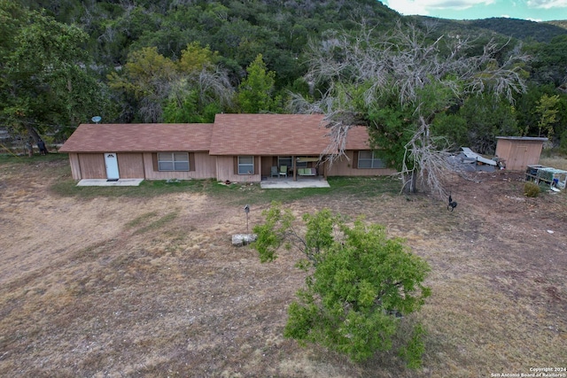 view of front of house with a patio area and a mountain view