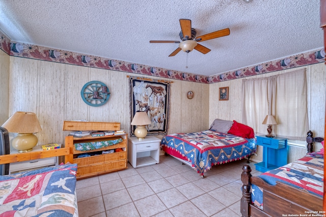 bedroom featuring a textured ceiling, light tile patterned flooring, and ceiling fan