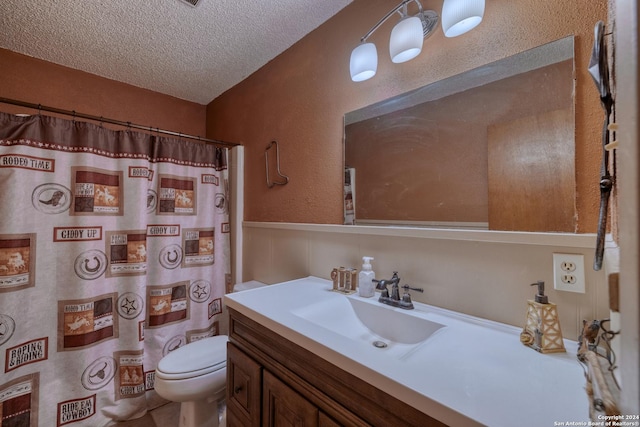 bathroom featuring a textured wall, toilet, a textured ceiling, vanity, and gas water heater