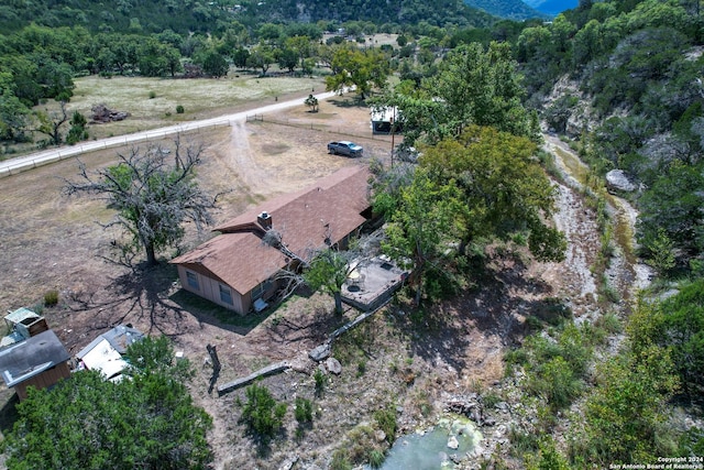 birds eye view of property with a view of trees