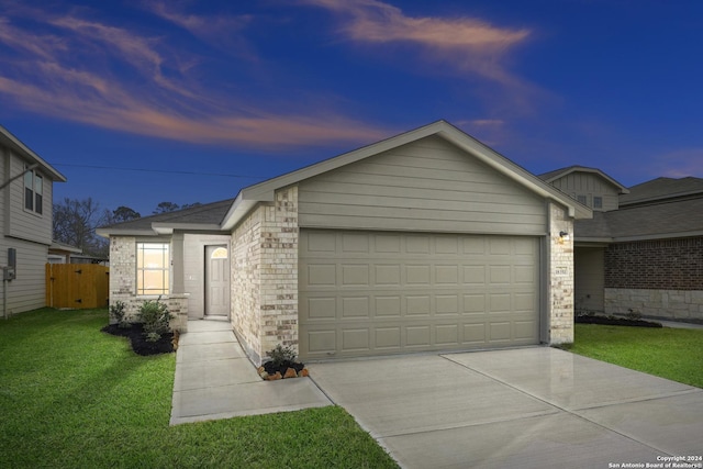 single story home with an attached garage, brick siding, fence, a yard, and driveway