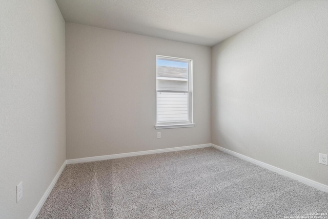 carpeted spare room with baseboards