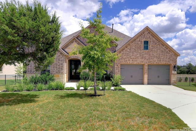 view of front of property with driveway, brick siding, stone siding, fence, and a front yard