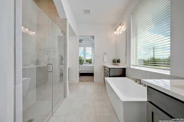 ensuite bathroom featuring a freestanding tub, visible vents, vanity, a stall shower, and ensuite bath