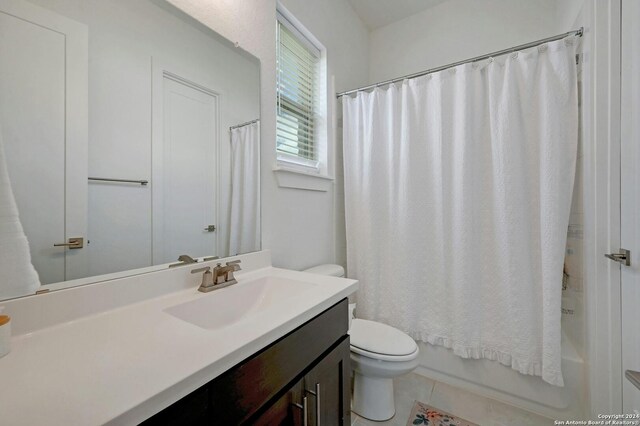 full bathroom featuring vanity, toilet, tile patterned floors, and shower / bath combo with shower curtain