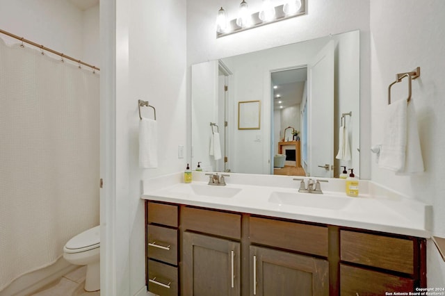 bathroom with tile patterned floors, vanity, toilet, and a shower with shower curtain