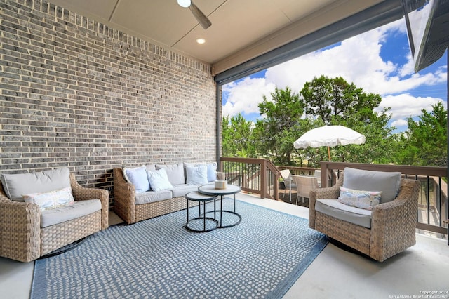 view of patio / terrace featuring outdoor lounge area, a wooden deck, and a ceiling fan